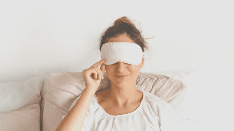 How to be unbothered. Image of a lady in bed with an eye mask on. She's smiling gently
